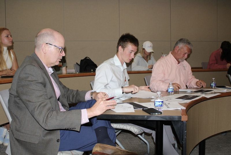Judges scoring student pitches at a pitch competition